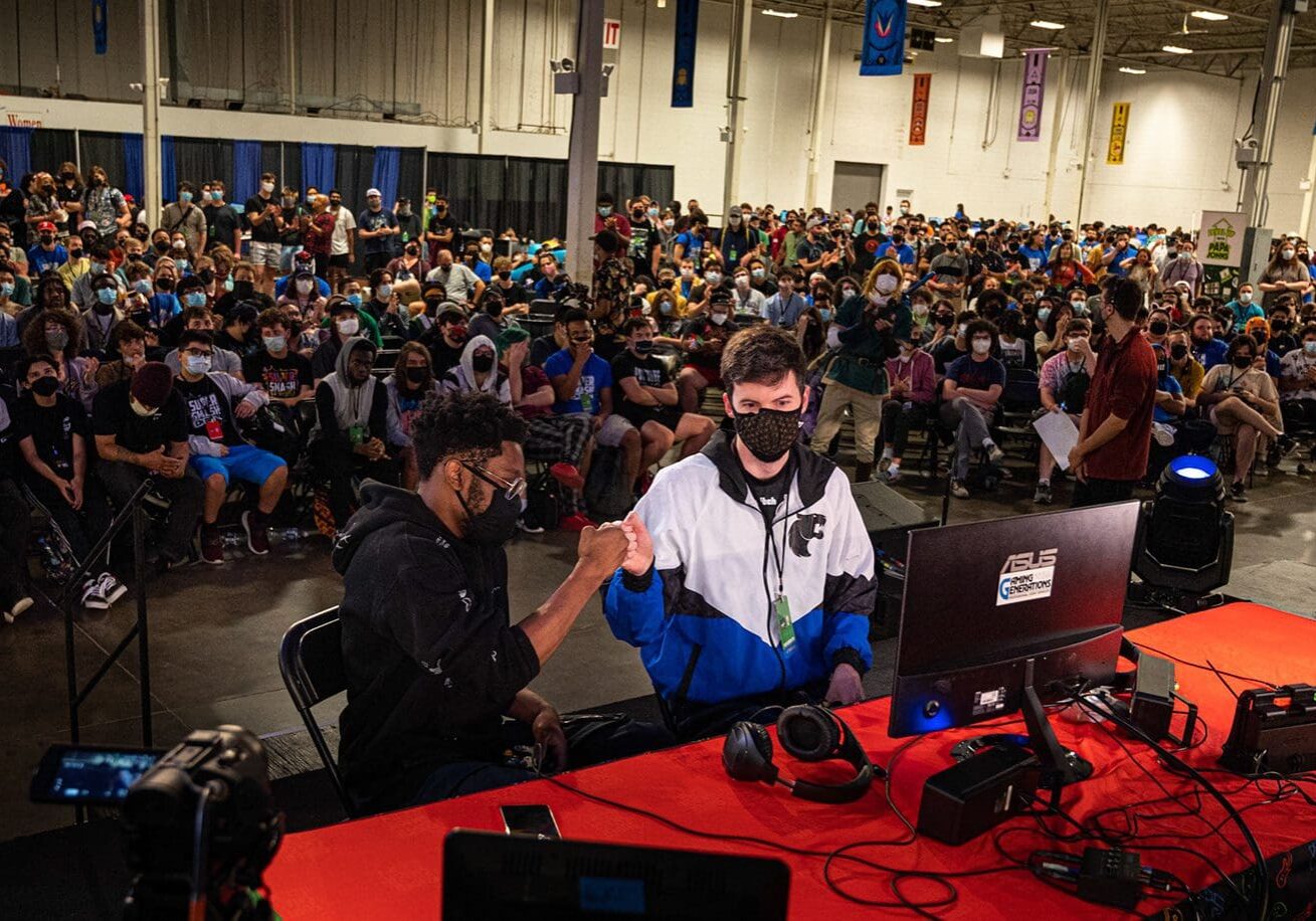 Two gamers competing in a fighting game tournament.